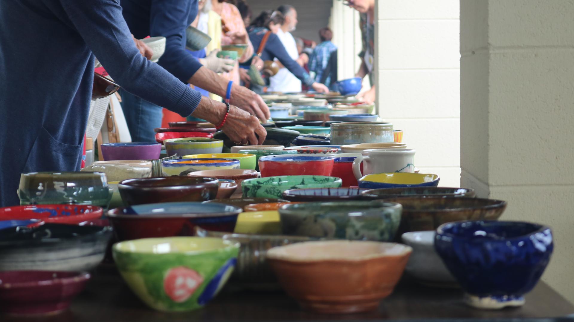 People selecting handcrafted bowls