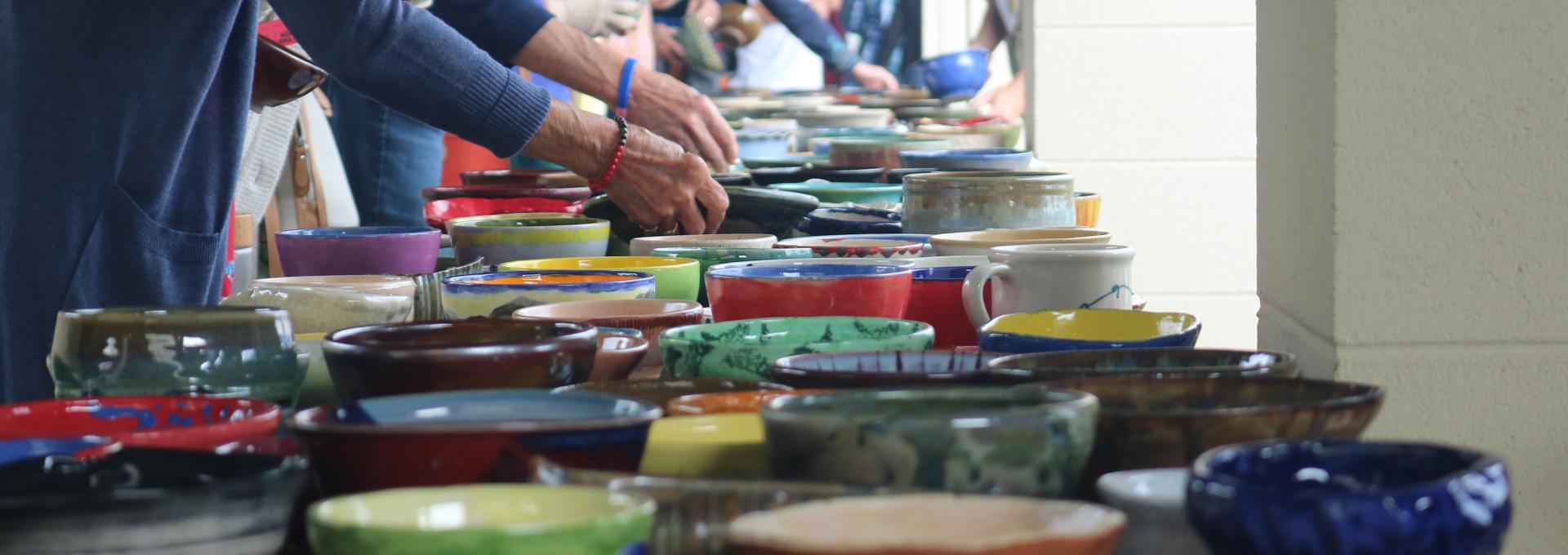 People selecting handcrafted bowls